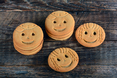 The smiling cookies on a wooden tableの写真素材