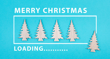 Wooden christmas trees on a blue colored background, loading bar, xmas iconの写真素材