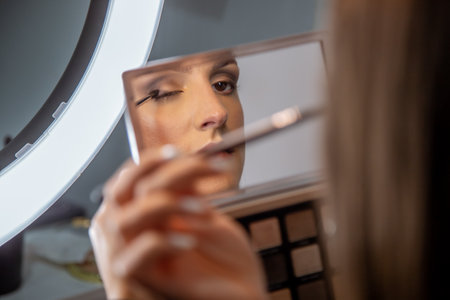 A closeup shot of a young caucasian female doing makeupの写真素材