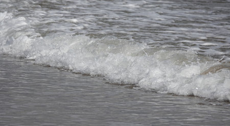 A beautiful view of waves breaking on the beach