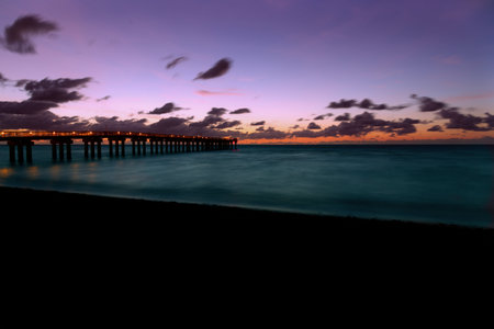 A beautiful view of a pier by the lake at sunsetの写真素材