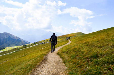 A beautiful view of a hiker in Seceda, Dolomitas, Italiaの写真素材