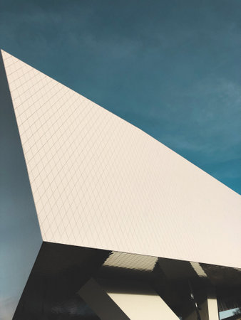 A low angle shot of a modern building under the cloudy skiesの写真素材