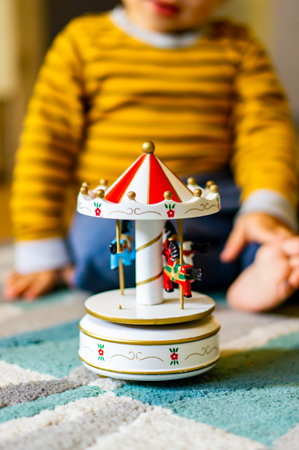 A vertical closeup of a colorful merry-go-round toy.の写真素材