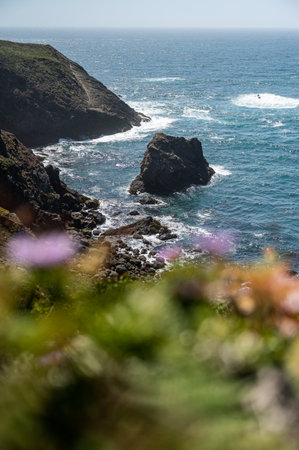 A vertical shot of cliffs and rock formations by the seaの写真素材