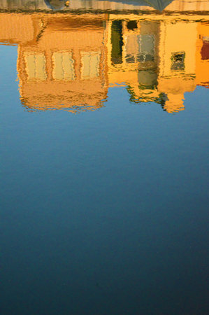 The reflection of the yellow buildings on the blue lakeの写真素材