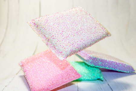 A closeup shot of scrubbing pads for cleaning on a white surfaceの写真素材