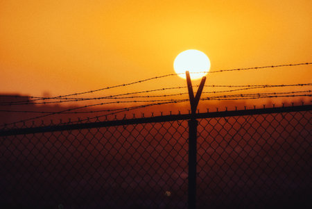 A fascinating colorful sunset and a fenceの写真素材