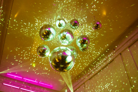 The shining disco balls hanging from the ceiling.の写真素材