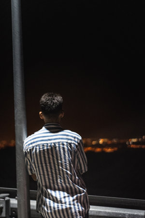 A vertical shot of a man on the cityscape backgroundの写真素材