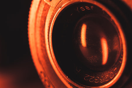 A macro shot of the camera lens under orange light.の写真素材