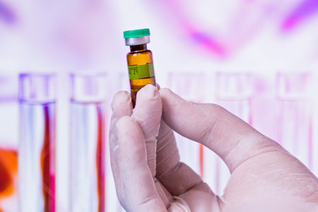 The gloved hands of a person holding a medicine bottle
