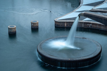 A decorative water out flow from the dam at Back Hoof Park in Lenexa, Kansas.の写真素材