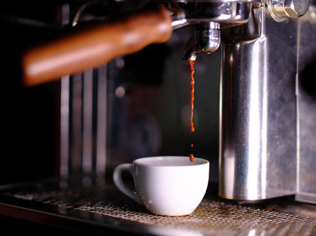 A close-up shot of an espresso running into a cup.の写真素材
