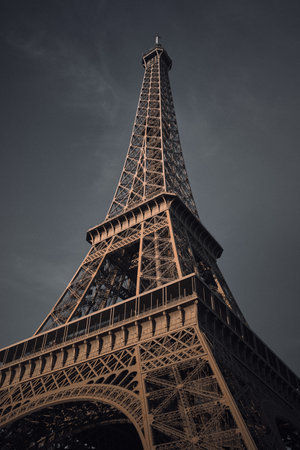 A low angle shot of the Eiffel tower in Prais, France during the gloomy weather
