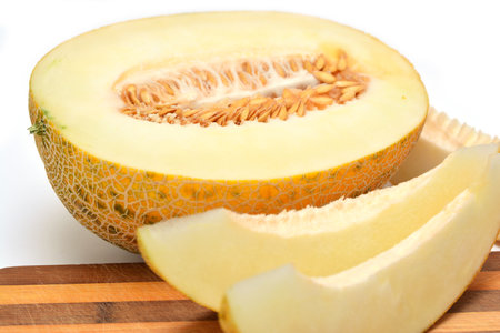 Fresh ripe melon and a wooden cutting board isolated on a white backgroundの写真素材