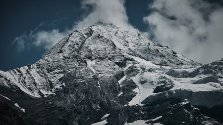 A low angle shot of snow-covered mountain peaks in