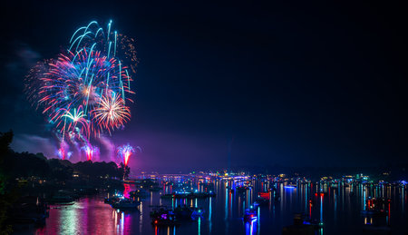A beautiful firework from the sea with illuminated boatsの写真素材