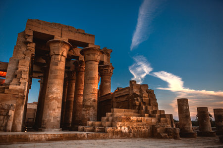 A minimizing vertical view of the Temple of Kom Ombo in Aswan, Egypt against a blue skyの写真素材
