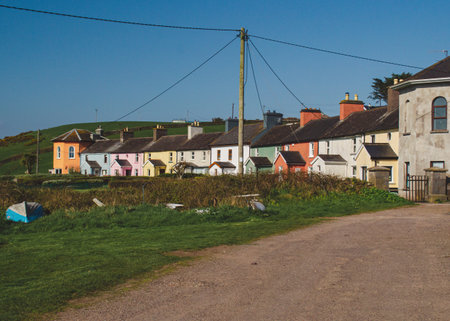 A line of colorful houses by the road in the morningの写真素材