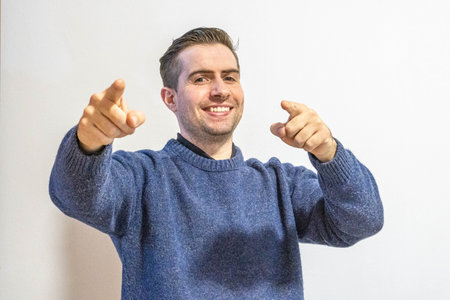 A closeup of the man in a blue sweater isolated on white background.