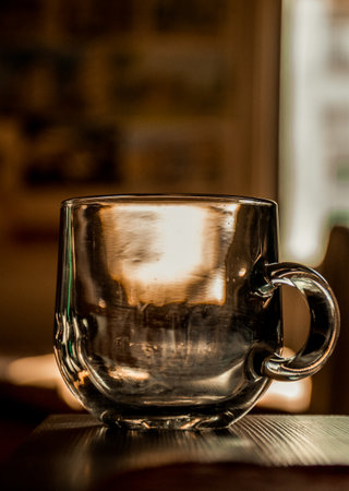 A vertical shot of an empty glass mug on the tableの写真素材