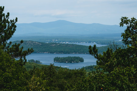 A landscape view of Lake Winnipesaukee surrounded by New Hampshire mountainsの写真素材