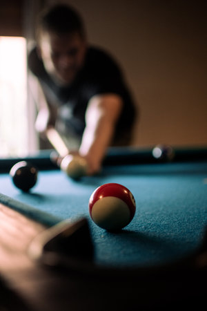 A Hispanic male playing billiard in a bar in Argentinaの写真素材
