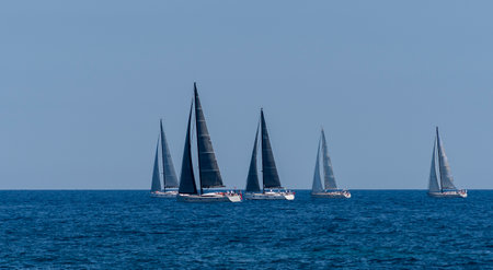 A group of sailboats floating on a blue seaの写真素材