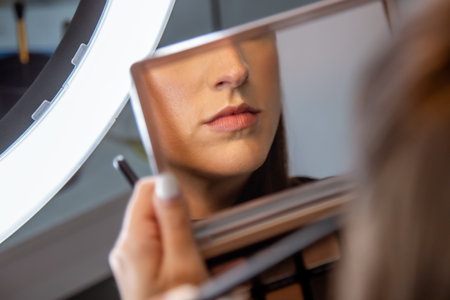 A closeup shot of a young caucasian female doing makeupの写真素材