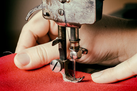 A woman sewing with a sewing machineの写真素材