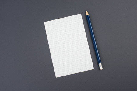 Empty paper with a pen on a dark grey background, copy space for text, busisness concept, education, minimalismの写真素材