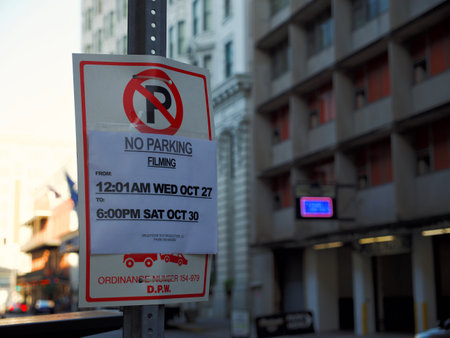 The parking hours information plate on a street pillarの写真素材
