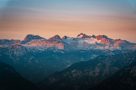 A sunrise in the Alps with alpenglow on the mountainsの写真素材
