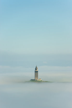 A beautiful view of the Tower of Hercules in the mist in La Coruna, Spainの写真素材