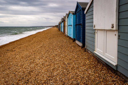 A scenic view of small, wooden cottages on the beach on a cloudy sky backgroundの写真素材