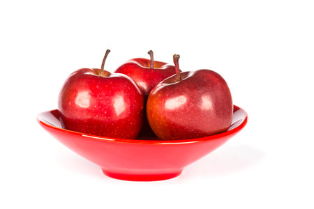 The red apples in plate isolated on white backgroundの写真素材