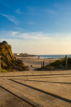 A vertical shot of a beach behind the rocks on a sunny dayの写真素材