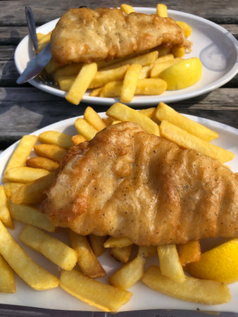 The fish and potato chips served on plates