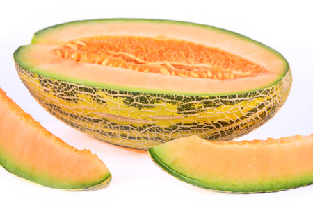 A fresh melon and slices isolated on a white background
