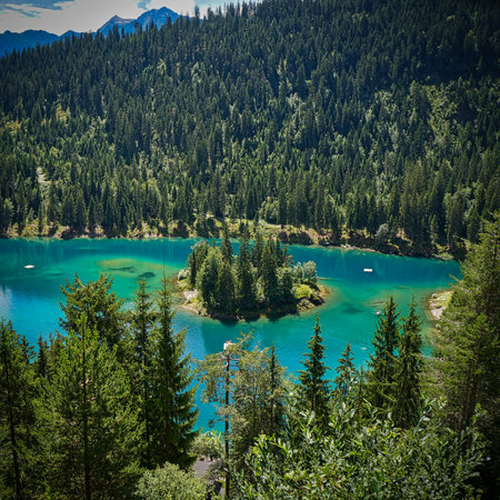 A beautiful landscape of the Caumasee Lake surrounded by forested mountains in Switzerlandの写真素材