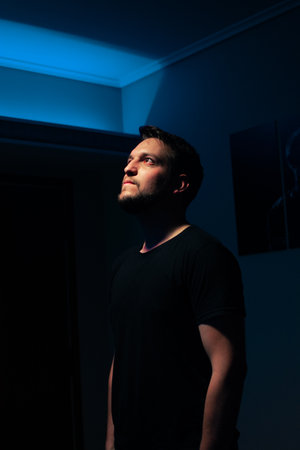 A closeup shot of a Hispanic male posing near a pool table in a bar