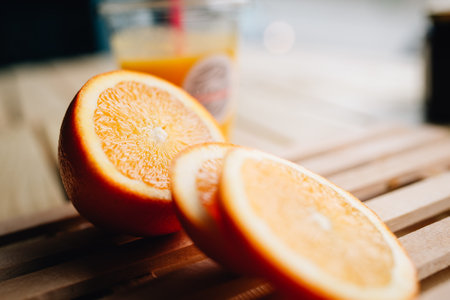 A sliced of fresh orange on a slatted wooden surfaceの写真素材