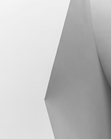 A low angle view of white wall and ceiling with shadowsの写真素材