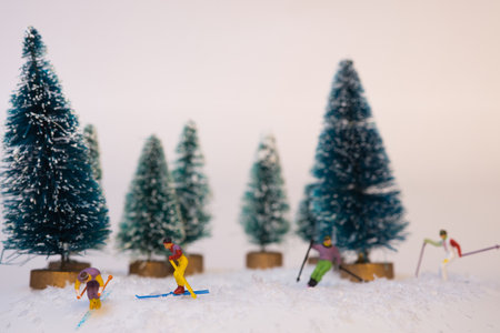 A group of miniature figures of skiers on a white backgroundの写真素材