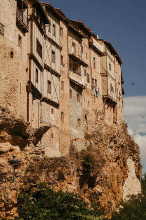 A vertical shot of old half-timbered houses in the province of Burgos, Spain on blue sky backgroundの写真素材