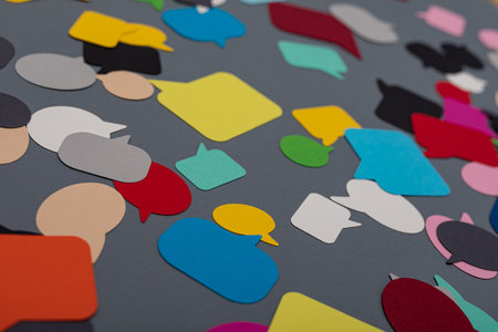 A table with many colorful communication papers speak bubblesの写真素材