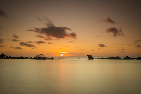 A beautiful view of a bright sunset over a calm seaの写真素材