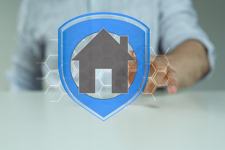 A home owner tapping on high-tech home security system hologramの写真素材