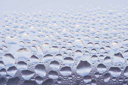 The macro shot of condensate on a window with water droplets.